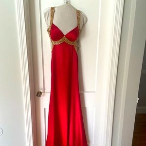 Beautiful red gown with gold trim and open back
